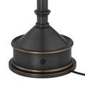 Close-up of lamp base featuring circular power button and bronze trim accents