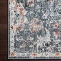 Close-up corner of rug on dark wood floor showing detailed pattern and edge binding