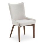 Posta dining chair angled view showing smooth fabric upholstery and gently reclined backrest