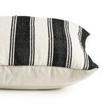 Side view of pillow showing thickness and striped cover over white backing