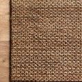 Natural woven jute rug with a subtle earthy texture and a variation of tan and brown shades
