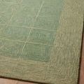 Angled close-up on the rug surface highlighting subtle color shifts and square grid texture