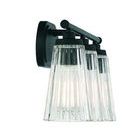 Close-up side view focusing on one ribbed clear glass shade with visible light bulbs inside