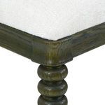 Close-up of padded seat corner with off-white upholstery and oak wood frame detail.