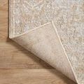 Back side of partially flipped corner revealing woven backing and edge stitching on wooden floor