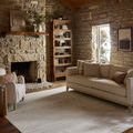 Townes rug styled in rustic living room with stone fireplace and cream sofa
