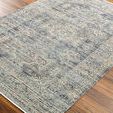 Close-up side angle showing rug's detailed woven texture and subtle color variations on hardwood floor