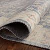 Folded section of Hathaway Denim / Multi Rug showing its thin, flexible polyester weave and underside.