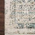 Close-up of the rug corner highlighting the texture, blue and gold accents, and the finely woven fringe on dark wood floor