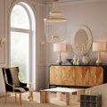 Mademoiselle Chandelier hanging in a sophisticated room with arched window and elegant furniture