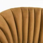 Close-up of upper back showing plush vertical channel tufting on bronze swivel chair
