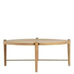 Round teak coffee table showing straight-on side view emphasizing slim legs and minimalist profile