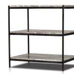 Partial side view showing three polished marble shelves and matte black iron bars