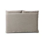 Back view showing smooth linen slipcover with minimal seams and two loose back cushions