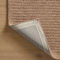 Corner lifted to reveal the natural backing and stitching details of the Kai Blush Rug