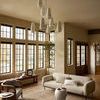 Heritage Clay / Natural rug in a bright sitting area with large windows, beige sofa, and armchair with wood and marble acc...