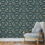 Wallpaper installed on wall showing scale with blue cushioned rattan chair and wood floor in cozy room setting