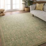 Rug displayed in a bright living room with beige sofa and wooden floor, showcasing scale and style