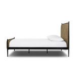 Side profile of the Xander Upholstered Bed showing the slim tapered black iron legs and frame