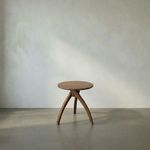 Side view of Vikram Side Table showing balanced three-legged base with natural teak wood finish