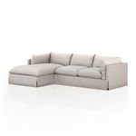 Angled front view showing dimensional seat cushions and chaise depth with fabric texture detail