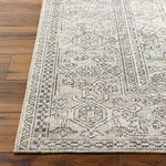 Close-up of corner edge on Margot rug highlighting detailed machine woven pattern and texture on wood floor