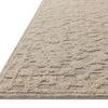Low-angle side view showing the rug’s depth and looped wool texture with raised floral design