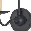 Close-up view from side of matte black round wall plate and curved arm with candle holder