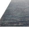 Angled side view showing low pile and edges of ocean grey rug with ribbed texture