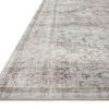 Close-up angled view showing textured polyester weave and faded blush and gray floral border detail