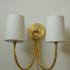 Upper view of sconce’s two shades and included brass ring detail on backplate