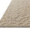 Side angle showing rug’s thickness and the texture difference between low-looped background and chunky raised loops