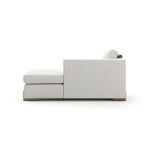 Side profile revealing the chaise’s low armrest and the thickness of the seat and back cushions