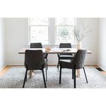 Silas Dining Table paired with modern dark gray quilted fabric chairs on a chunky textured rug