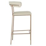 Side profile emphasizing stool’s slim brass-finished frame and footrest
