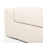 Close-up of seam between seat cushion and armrest highlighting stitching and fabric weave