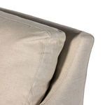 Tight zoom on stitched seam joining back cushion and sloping arm structure