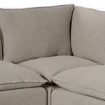 Close-up of corner cushions showing feather-blend softness and relaxed slipcover edges