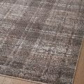 Close horizontal view of rug surface showing fine detailed plaid weave and flat texture