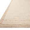Rug close-up showing side angle with detailed textured pile and natural beige edge