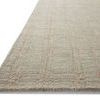 Close-up angled view showing the low pile and textured grid detail of the Polly Fog / Wheat Rug