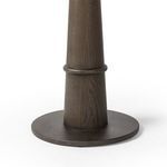 Bottom circular base of medium brown oak table with wood grain visible