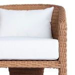 Bottom close-up showing black glides on the angled wicker legs of the chair