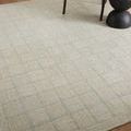 Close-up view of Francis Silver / Sky Rug showing texture and light blue grid detail on hardwood flooring