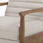 Detail of armrest corner with smooth walnut finish and upholstery stitching