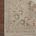 Close-up of Rosemarie Ivory Natural Rug corner on dark wood floor showcasing intricate distressed floral details
