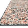 Close-up angled view showing low pile texture and detailed border with navy and rust colors