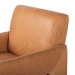 Close-up of high-quality tan leather upholstery on backrest of the chair