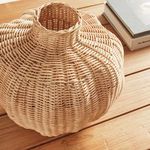 Side close-up showing curved body and loose weave texture of Evren Vase on wood tabletop