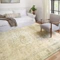 Rosette Sand / Ivory Rug styled in a bright room with white sofa and modern armchair